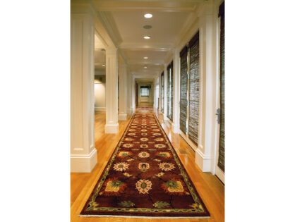 A hallway with a long rug on the floor